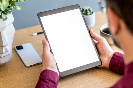 Modern business composition on the home office with freelancer, mock up tablet screen, plant, notes,...