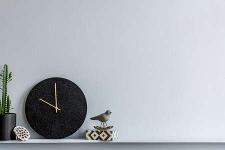 Minimalistic composition on the wooden shelf with dried flowers in vase and elegant personal...