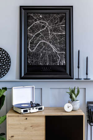 Modern scandinavian home interior with mock up poster frame, design wooden commode, lamp, plants,...