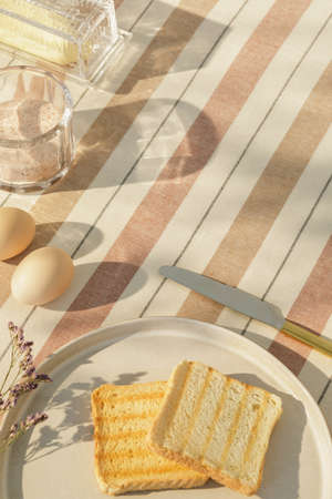 Stylish composition of outdoor kitchen space with wooden table, food, drinks, kitchen accessories,...