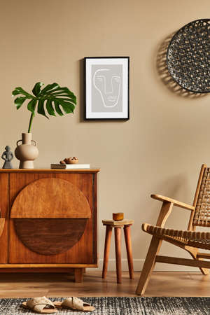 Interior design of unique living room with stylish commode, armchair, tropical leaf in vase, mock up poster on the wall, decoration and personal accessories in modern home decor. Template.の写真素材