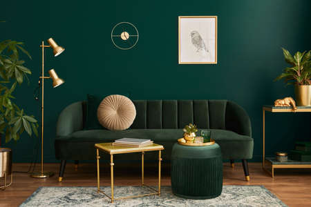 Luxury living room in house with modern interior design, green velvet sofa, coffee table, pouf, gold...