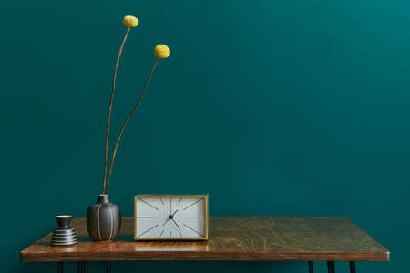 Stylish concept of living room interior with walnut table, flowers in vase, clock and elegant...
