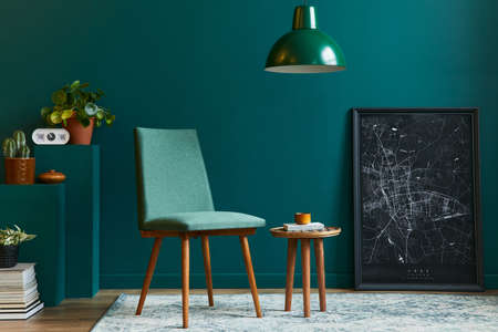 Stylish concept of living room interior with design chair, tropical leaf in vase, black mock up poster map, retro carpet, decoration, cacti, pendatn light, book and accessories in modern vintage home decor.の写真素材