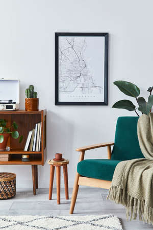 Stylish interior of living room with design wooden shelf, velvet sofa, plants, mock up poster map,...