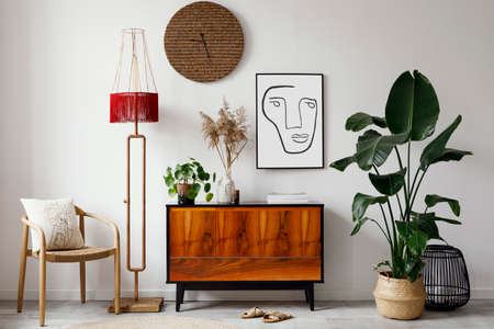 Creative composition of stylish living room inerior design with mock up poster frame, wooden...