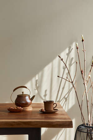 Minimalist concept of dining room interior with wooden family table, cup of coffee, tea jug,...