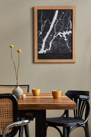 Stylish dining room interior with mock up poster map, wooden walnut table, design chairs, cup of...