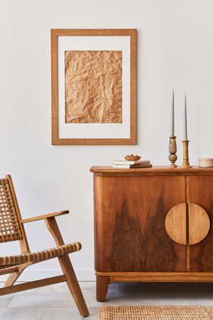 Minimalist composition of living room with brown mock up picture frame, plant, retro armchair, dried...