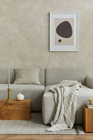 Creative composition of stylish modern spacious living room with mock up poster frame, gray sofa,...