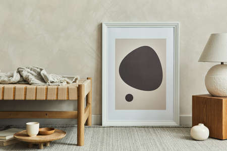 Stylish composition of cozy living room interior with mock up poster frame, plaid on the chaise longue, white lamp on the wooden cube and elegant personal accessories. Neutral wall, carpet on the floor. Template.の写真素材