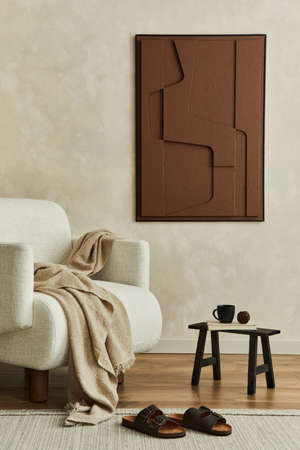 Stylish composition of modern living room interior with structure painting on the wall, beige armchair and personal accessories. Neutral creative wall, carpet on the parquet floor. Template.の写真素材