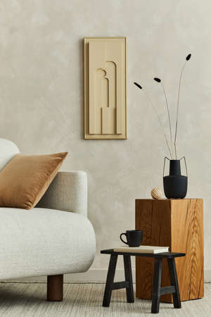 Stylish composition of modern cozy living room interior with structure painting, beige armchair, wooden coffee table and personal accessories. Neutral creative wall, carpet on the floor. Template.の写真素材