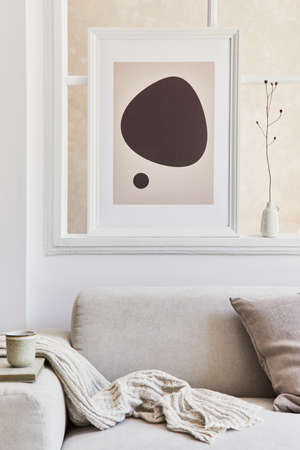 Creative composition of stylish and cozy living room interior with mock up poster frame, gray corner...