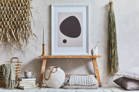 Stylish composition of cozy living room interior with mock up poster frame, bench in retro style, clay vases, crockery and straw decoration. Rustic inspiration. Summer vibes. Beige wall. Template.の写真素材