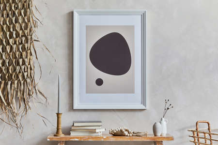 Stylish composition of cozy living room interior with mock up poster frame, bench in retro style, clay vases, crockery and straw decoration. Rustic inspiration. Summer vibes. Beige wall. Template.の写真素材