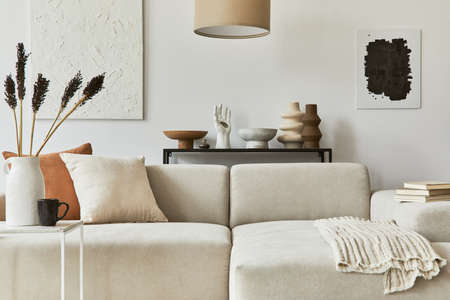 Stylish composition of cozy living room interior design with mock up poster frame and structure painting, corner sofa, coffee table, textile and personal accessories. Scandinavian classic style.の写真素材