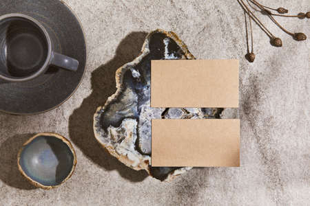 Creative interior flat lay composition with mock up visit cards, rocks, natural materials, dry...