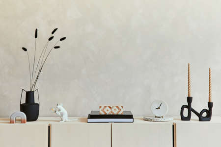 Elegant composition of stylish living room intrerior with beige sideboard and minimalistic personal...