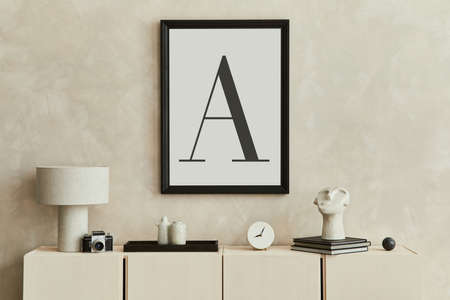 Creative and modern beige living room interior design with mock up poster frame, beige wooden...