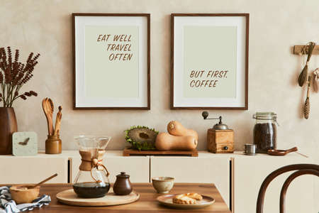 Elegant composition of creative dining room intrerior with mock up poster frames, beige sideboard, family dining table, vegetables and vintage personal accessories. Copy space. Template. Autumn vibes.の写真素材