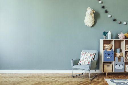 Creative composition of stylish and cozy child room interior design with eucalyptus wall, plush toys, furniture and accessories. Parquet floor. Copy space. Template.の写真素材