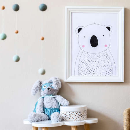 Stylish scandinavian nursery interior with mock up photo frame, plush toy, design furniture, toys...