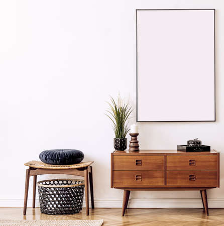 Stylish and retro living room with design vintage wooden commode, chair, footrest, black lamp and...