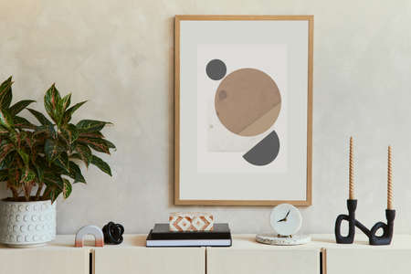 Stylish composition of modern living room interior with mock up poster frame, wooden sideboard and boho inspired accessories. Template.の写真素材