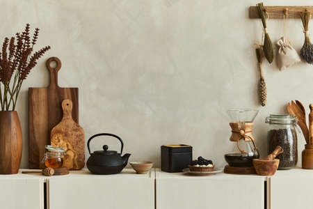 Stylish composition of modern kitchen interior design with copy space, beige sideboard and classy black accessories. Template. Autumn vibes.の写真素材