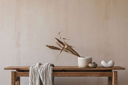 Elegant interior composition with elegant wooden bench. Beautiful decorations and accessories. Modern home interior design. Retro inspiration. Copy space. Structure wall. Template.の写真素材