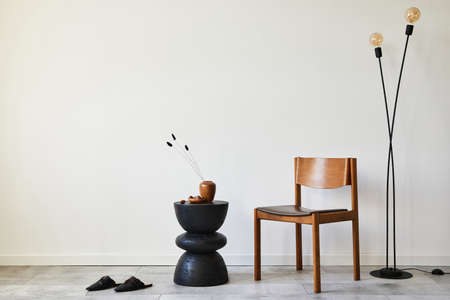 Modern composition of stylish livng room interior with creative vintage chair, side table and...