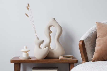 Creative living room interior design composition with handmade vases, side table, fluffy armchair and personal accessories. Copy space. Wallpaper. Template.の写真素材