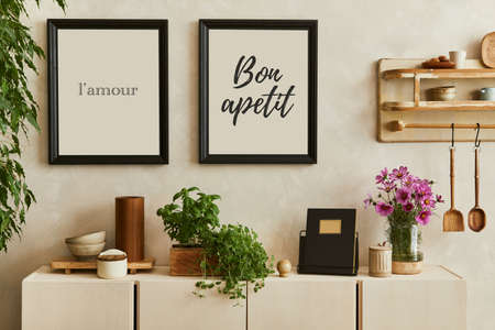 Stylish composition of cozy kitchen interior design with mock up poster frames, beige commode and...