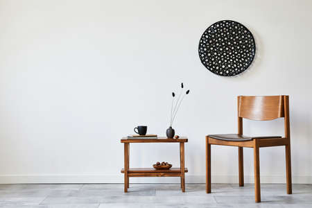 Modern composition of stylish livng room interior with creative vintage chair, side table and...
