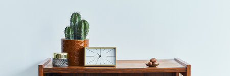Stylish scandinavian living room interior with retro commode, clock, cacti, decoration, book and personal accessoreis in home decor. Template. Copy space.の写真素材