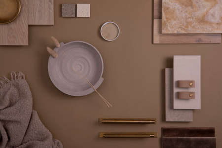 Creative flat lay composition of interior designer moodboard with textile and paint samples, panels and tiles. Beige, brown and gray color palette. Copy space. Template.の写真素材