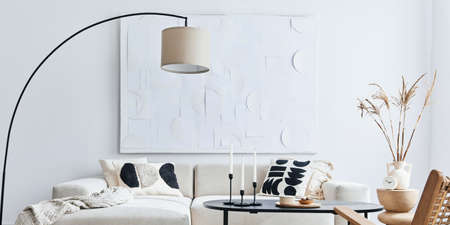 Domestic interior of living room with design modular sofa, black coffee table, lamp, armchair, decoration, art paintings and elegant personal accessories in modern home decor. Template.の写真素材