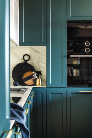 Modern bright bathroom with lamella wall. Big white bath with silver faucet and brown towel.の写真素材