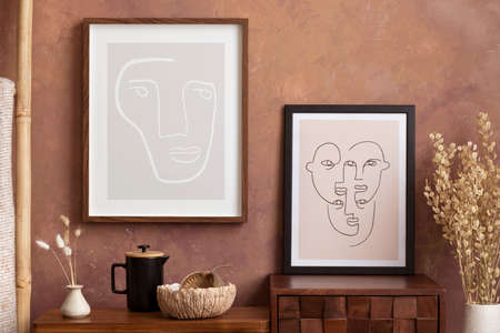 The stylish compostion at living room interior with mock up, design wooden sideboard, vase and elegant personal accessories. Brown wall Cozy apartment. Mock up poster. Template.の写真素材