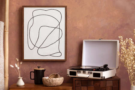 The stylish compostion at living room interior with mock up, design wooden sideboard and elegant personal accessories. Brown wall Cozy apartment. Home decor. Template.の写真素材