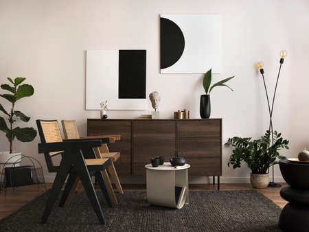The stylish compostion at living room interior with copy space, rattan chairs and elegant personal accessories. White wall. Cozy apartment. Mock up poster. Template.の写真素材