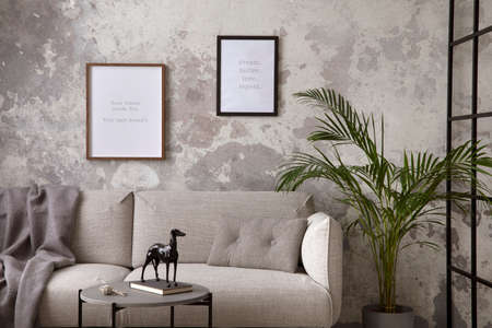 The stylish compostion at living room interior with design gray sofa, coffee table, plant, hanger,...