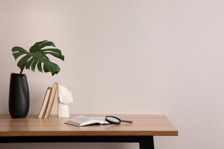 The stylish composition of cozy office interior with metal chair, wooden table, plants, pictures and personal accessories. Home decor. Template.の写真素材
