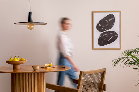 Interior design of domestic dining room space with two mock up poster frames, round table, chair, pedant lamp, decoration and woman in jeans. Minimalist home decor. template.の写真素材
