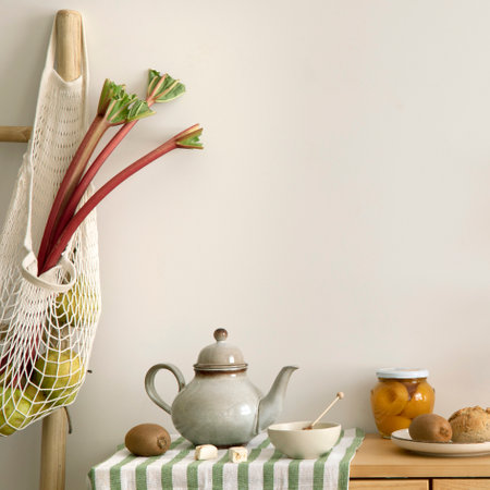 Warm and cozy interior design of kitchen space with rattan commode, ladder, hanger on the wall, herbs, vegetables, pitcher, avocado, pears, food and kitchen accessories. home dÃ©cor. template.の写真素材