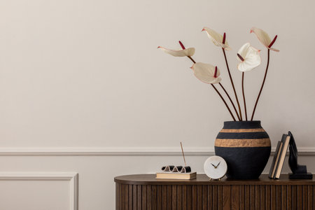 Minimalist composition of living room interior with copy space, woden sideboard, clock, books, vase...