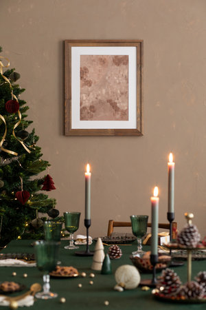 Christmas tree with candles and gingerbread cookies on green table at homeの写真素材