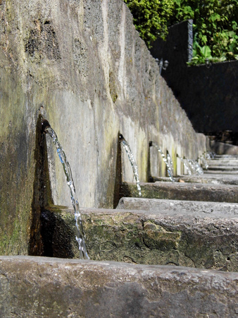 The old washinghouse Old communal wash basins, where people used to do their laundry with running water to individual sinks. Long perspective. The picture was taken in Baño, Ecuadorの写真素材