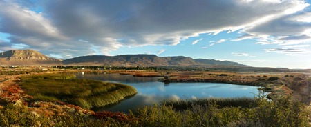 Nimez Lagoon at the golden hourThe idyllic Nimez Lagoon at the golden hour.Surrounded by reeds and topped by a cloudy sky.Remarkable reflection and precious light for this wide panorama.The picture was taken in El Calafate, Argentinaの写真素材